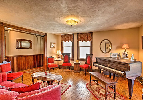 tenal living room with baby grand piano